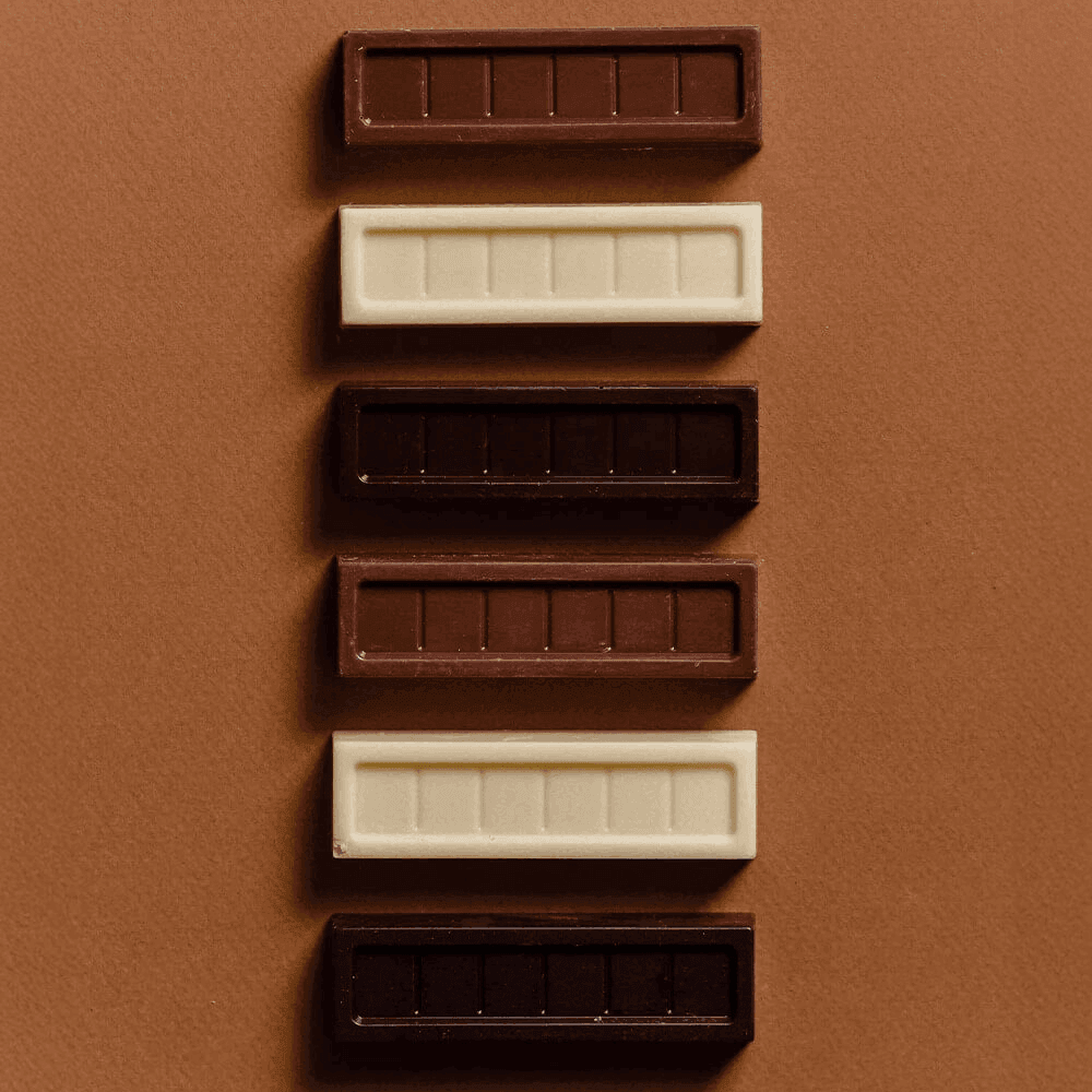 Barritas de chocolate blanco 29%, leche 35% y amargo 63%